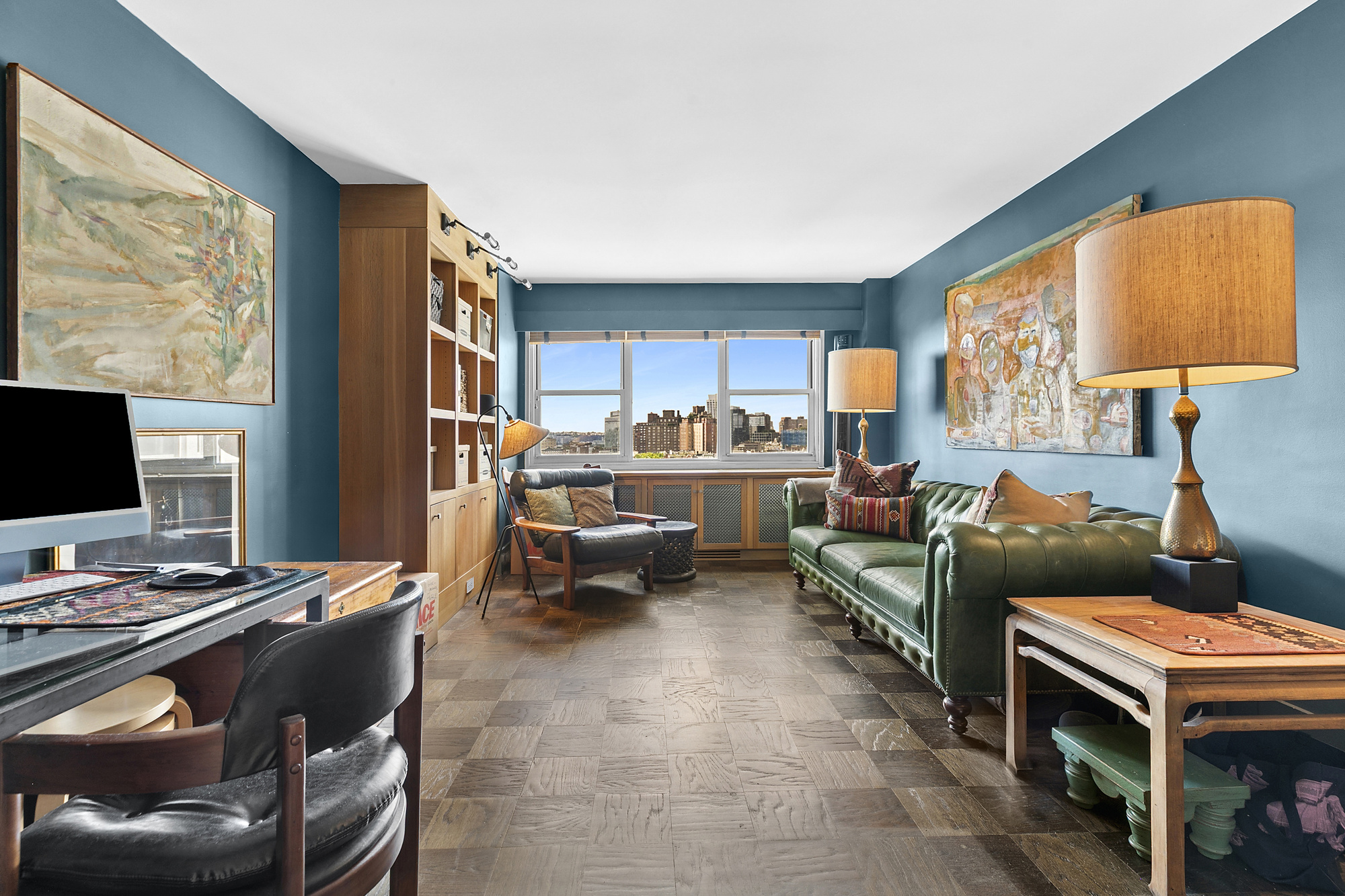 3 Sheridan Square, Unit 15A Manhattan, NY 10014 - Photo 2 of 11 a living room with furniture and a flat screen tv