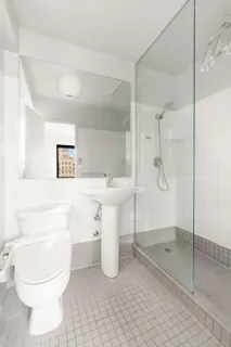 a bathroom with a sink toilet and shower