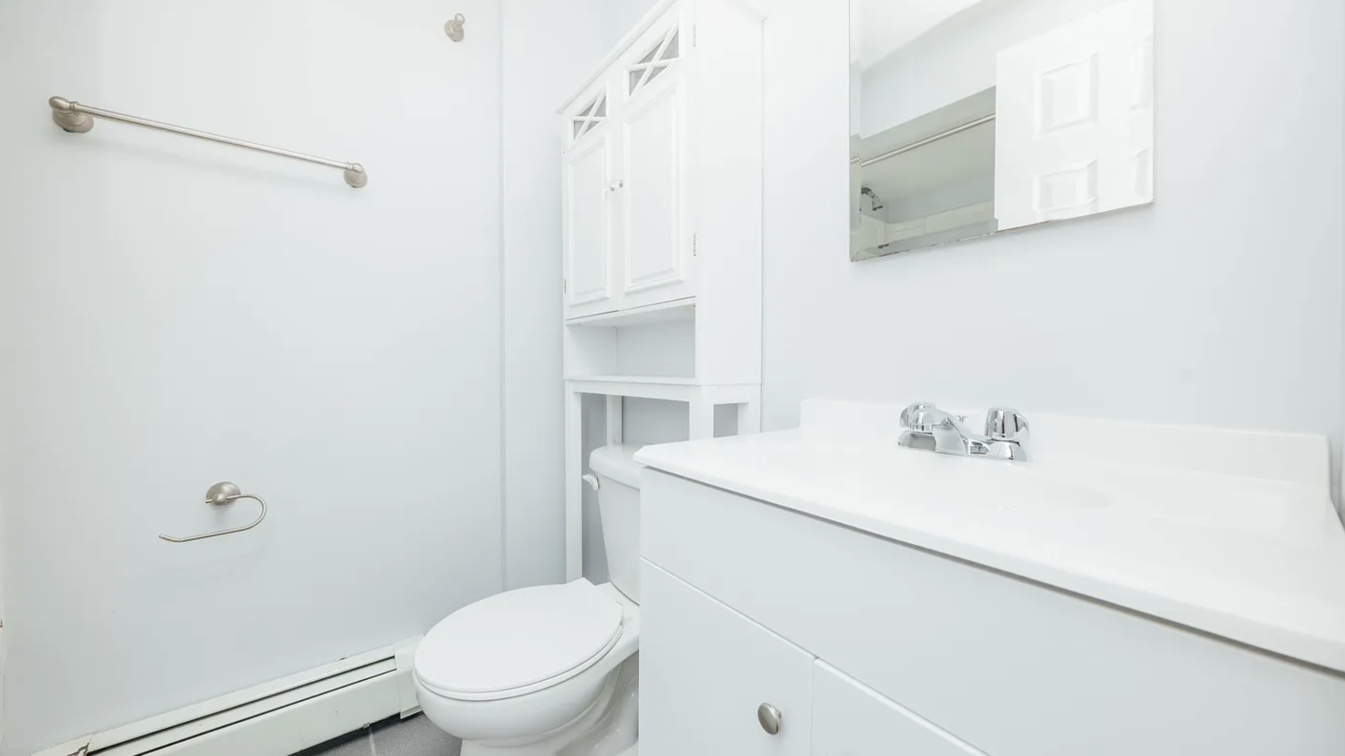 132 Jefferson Street, Unit 3L Brooklyn, NY 11206 - Photo 12 of 12 a bathroom with a sink a toilet and a mirror