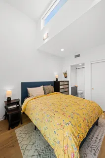 a bedroom with a bed and a couch