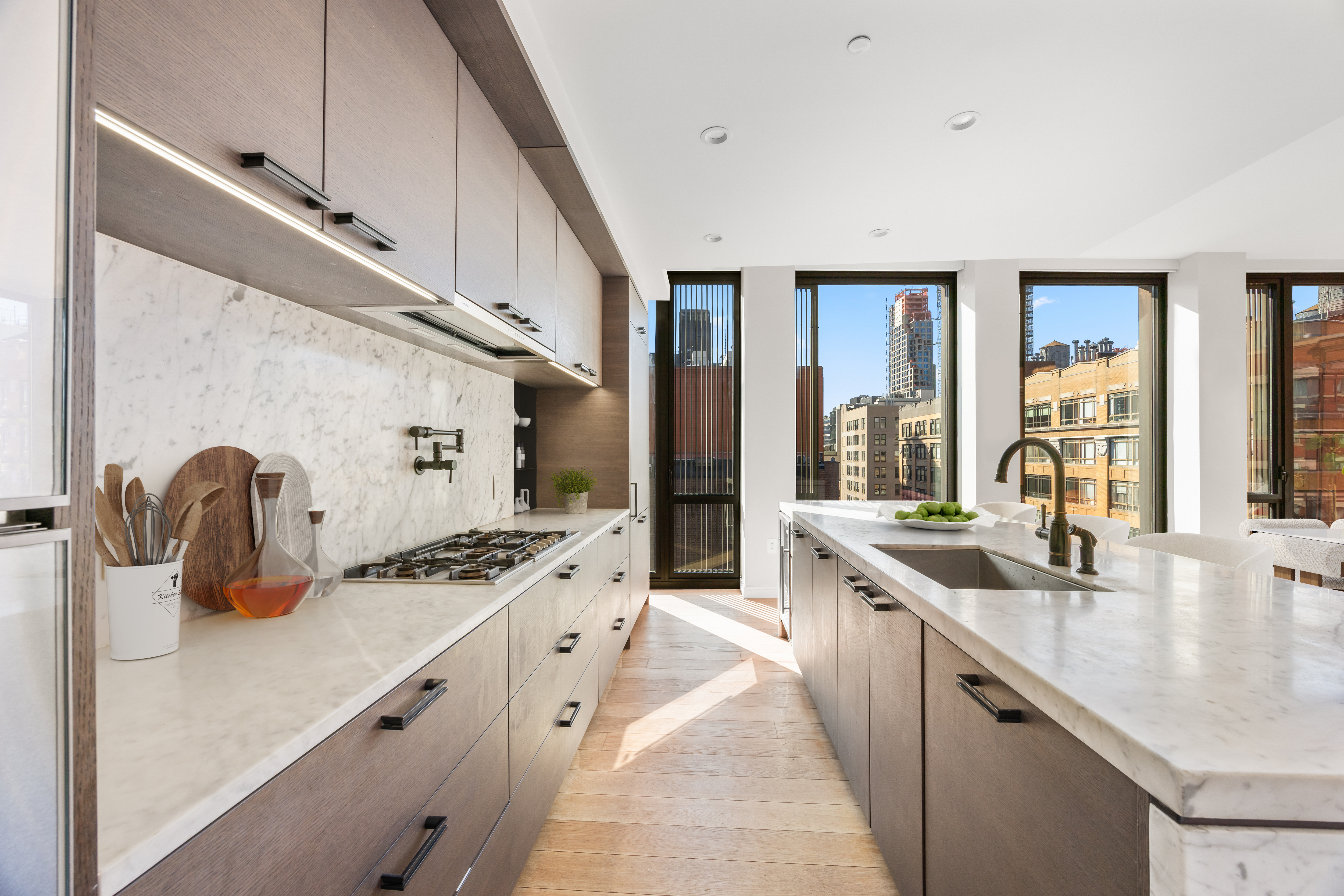100 Barrow Street, Unit 9A Manhattan, NY 10014 - Photo 5 of 12 a kitchen with sink a stove and cabinets
