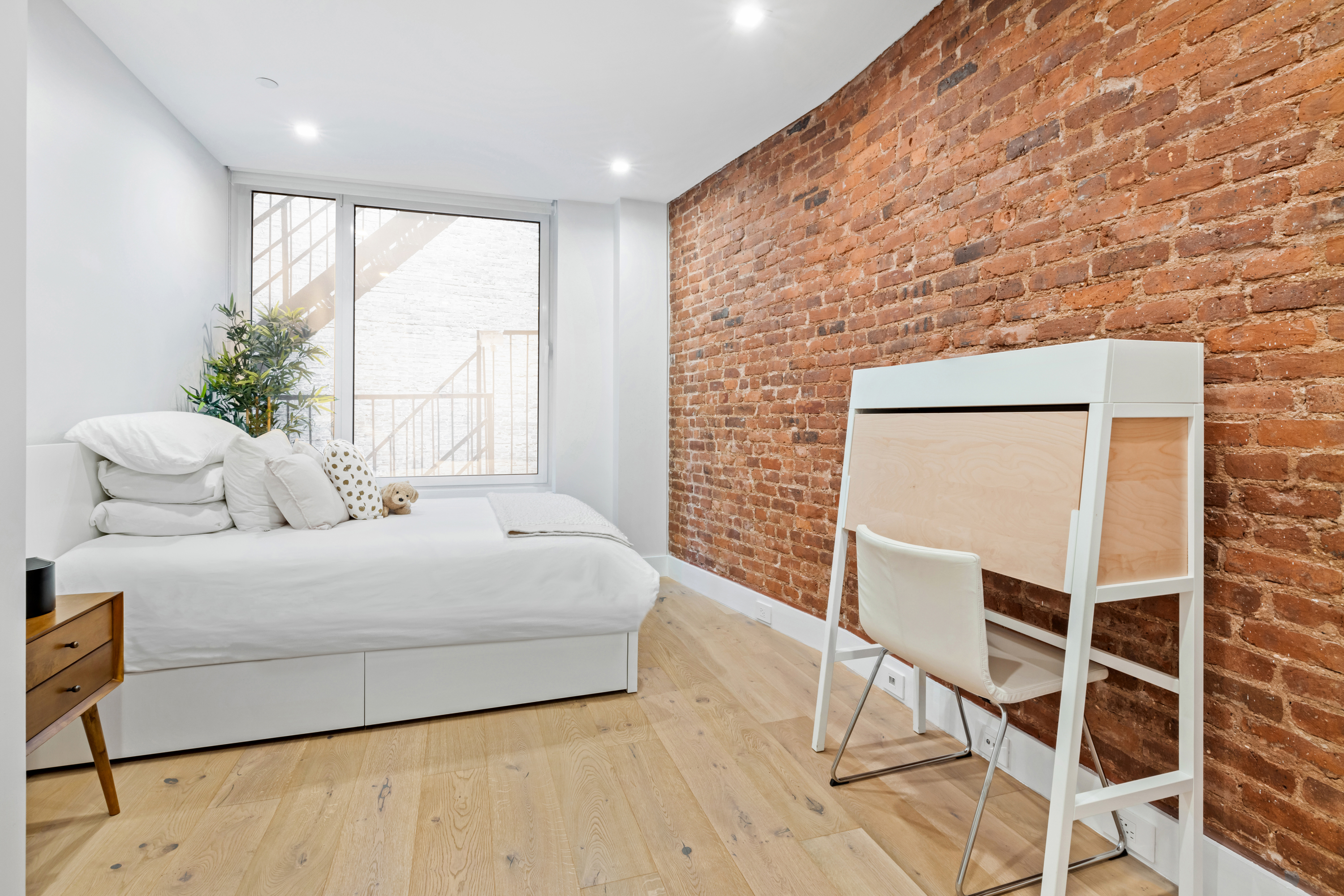 17 East 17th Street, Unit 4 Manhattan, NY 10003 - Photo 8 of 11 a bedroom with a bed and a window