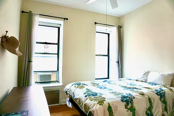 30 East 95th Street, Unit 2E Manhattan, NY 10128 - Photo 5 of 6 a bedroom with a bed and a window