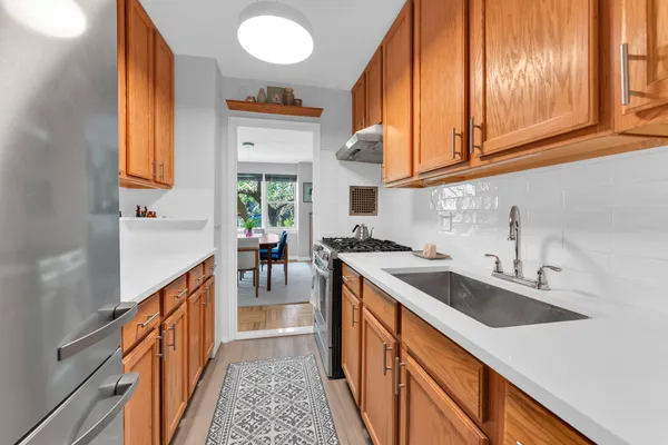 a kitchen with stainless steel appliances granite countertop a sink and a stove