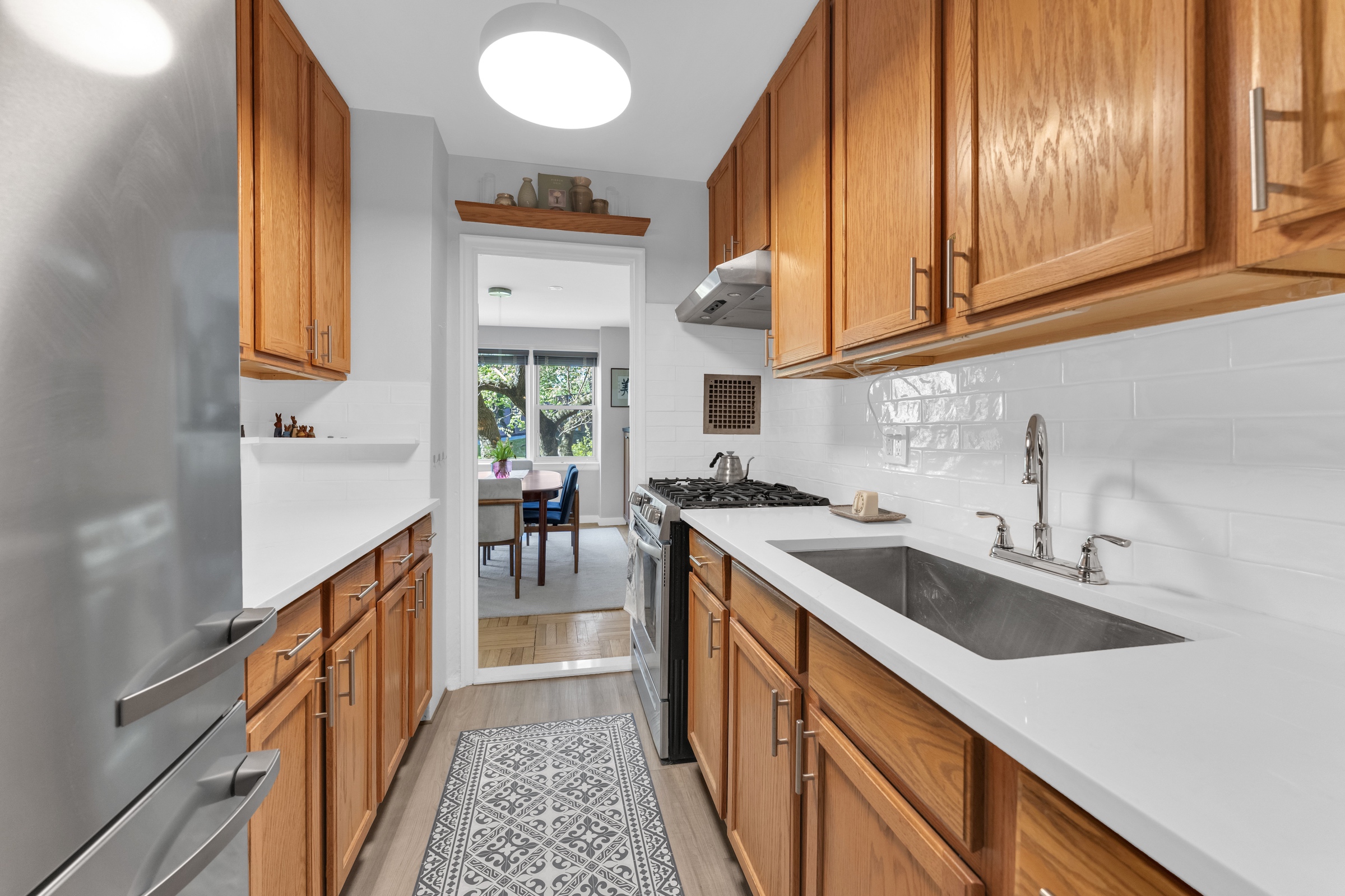 4555 Henry Hudson Parkway West, Unit A310 Bronx, NY 10471 - Photo 8 of 16 a kitchen with stainless steel appliances granite countertop a sink and a stove
