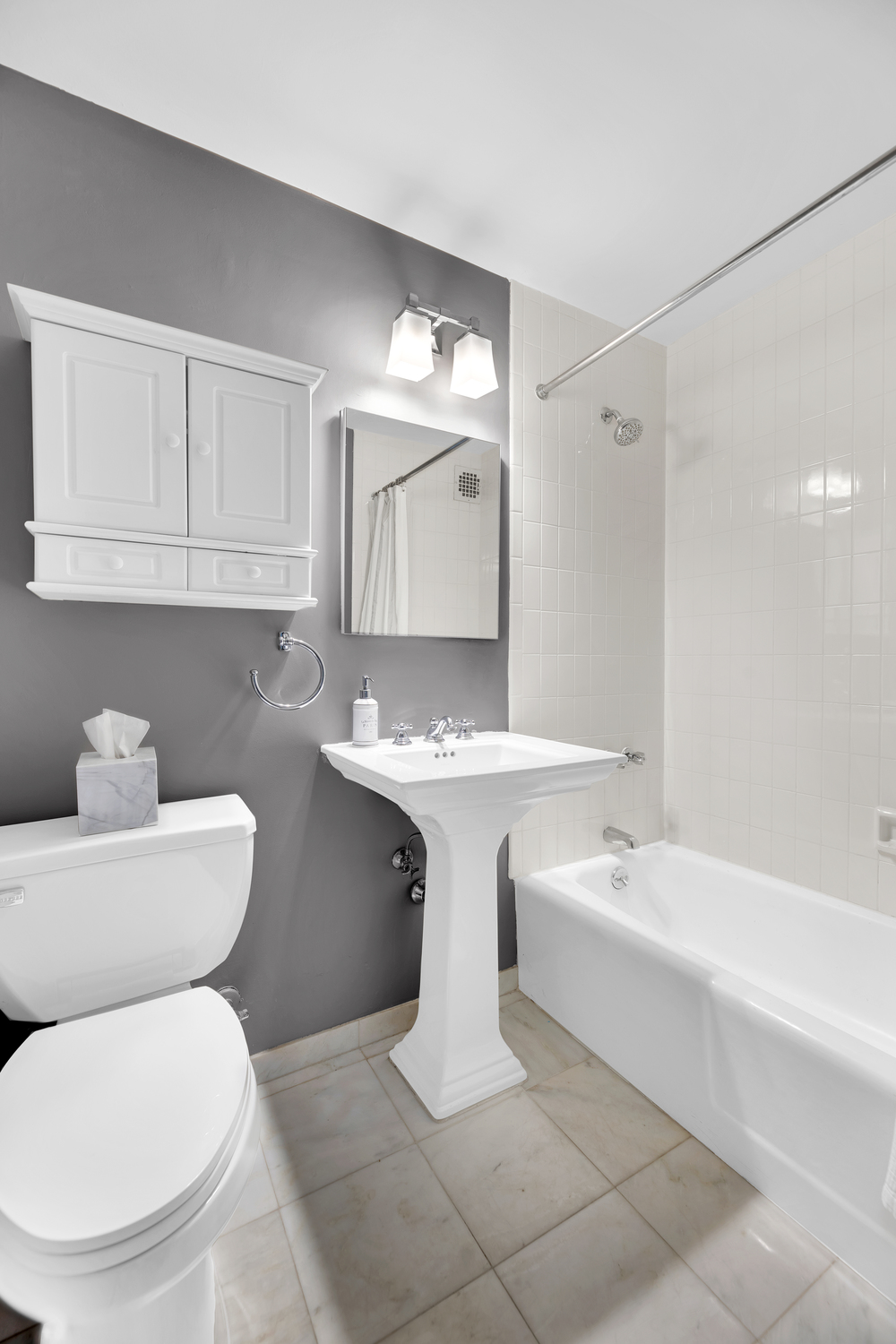 23 East 10th Street, Unit 321 Manhattan, NY 10003 - Photo 6 of 10 a bathroom with a toilet sink and mirror