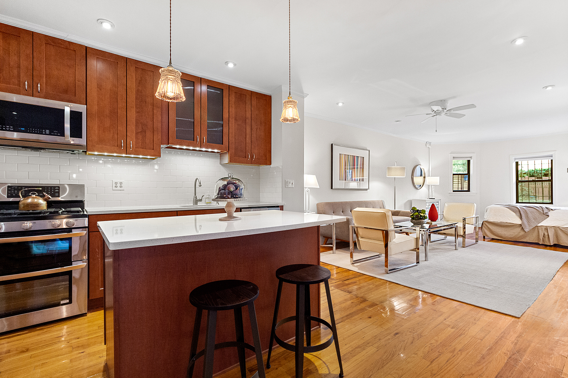579 5th Street Brooklyn, NY 11215 - Photo 14 of 19 a large kitchen with stainless steel appliances granite countertop a stove a sink dishwasher a dining table and chairs with wooden floor