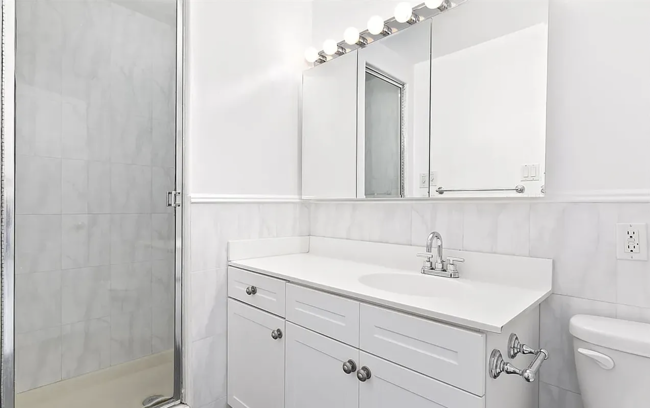 343 East 76th Street, Unit 6B Manhattan, NY 10021 - Photo 6 of 8 a bathroom with a sink and a mirror