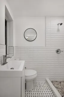 a bathroom with a sink toilet and shower