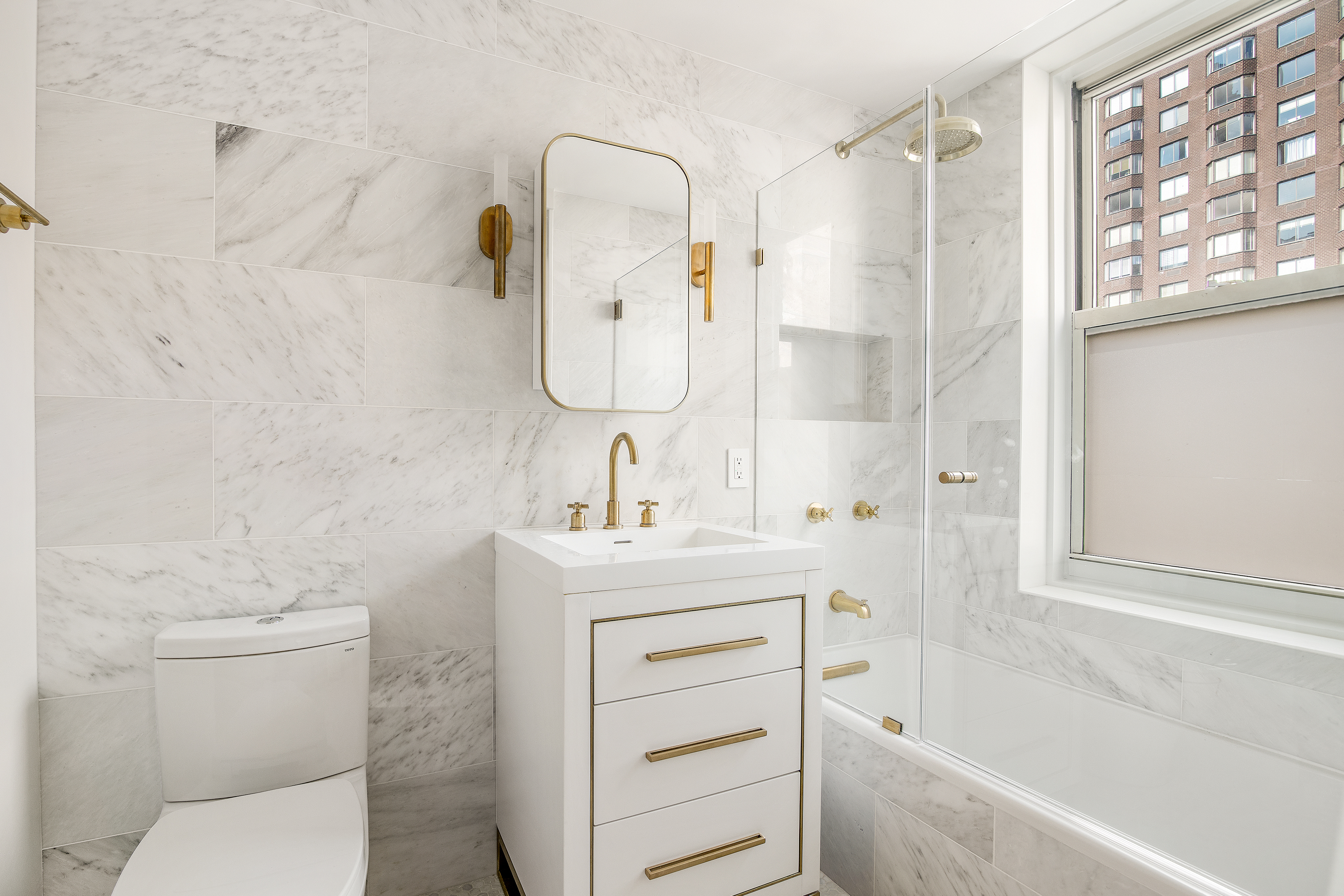 434 East 52nd Street, Unit 10E Manhattan, NY 10022 - Photo 7 of 13 a bathroom with a sink toilet and shower