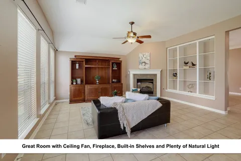 a living room with furniture a fireplace and a flat screen tv