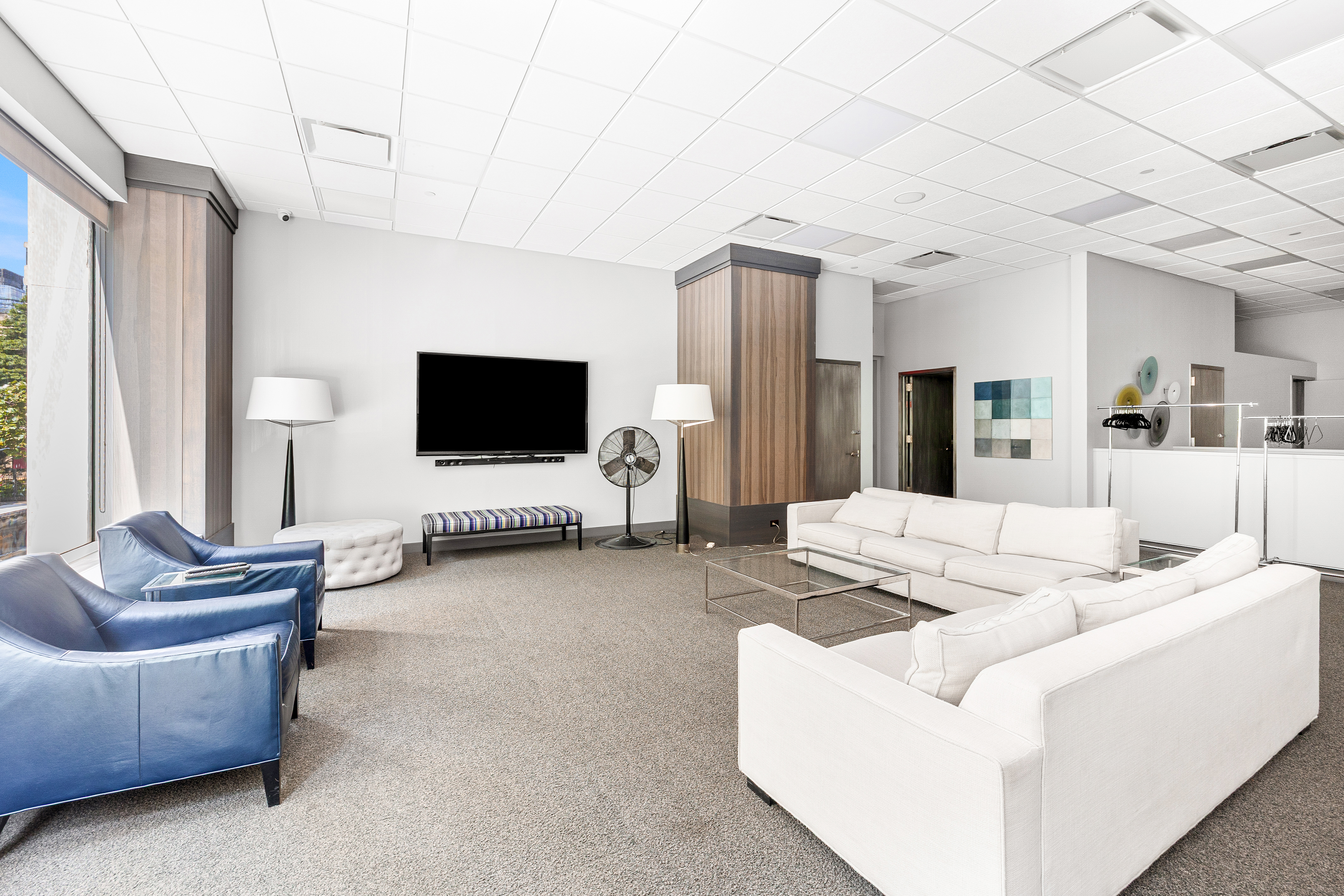 61 West 62nd Street, Unit 17L Manhattan, NY 10023 - Photo 8 of 10 a living room with furniture and a flat screen tv