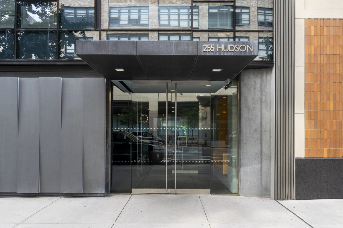 255 Hudson Street, Unit TH3 Manhattan, NY 10013 - Photo 9 of 11 a front view of a building with glass door
