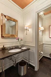 a bathroom with a sink a toilet and a mirror