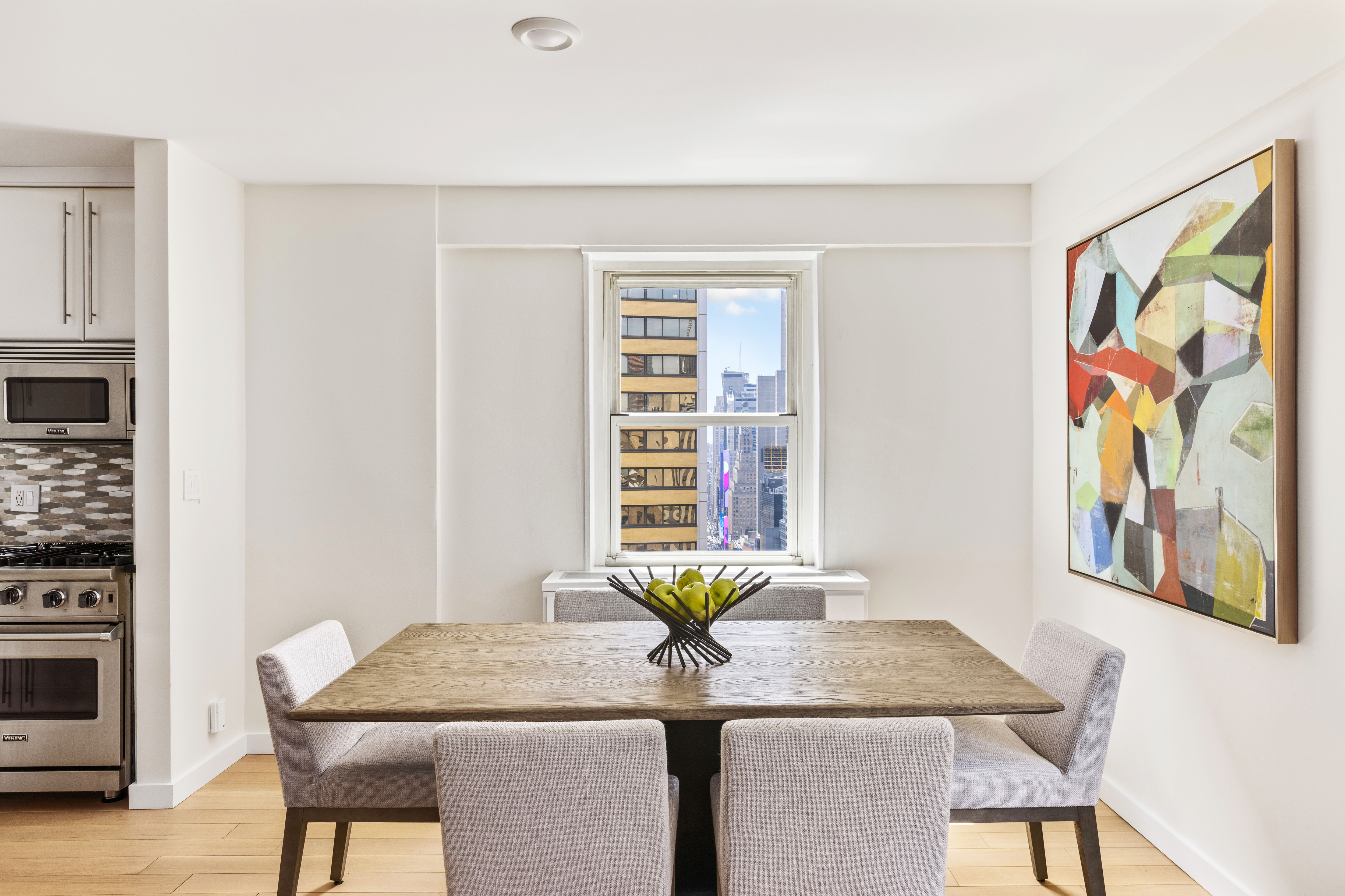 159 West 53rd Street, Unit 34E Manhattan, NY 10019 - Photo 6 of 15 a dining room with table chairs and wooden floor