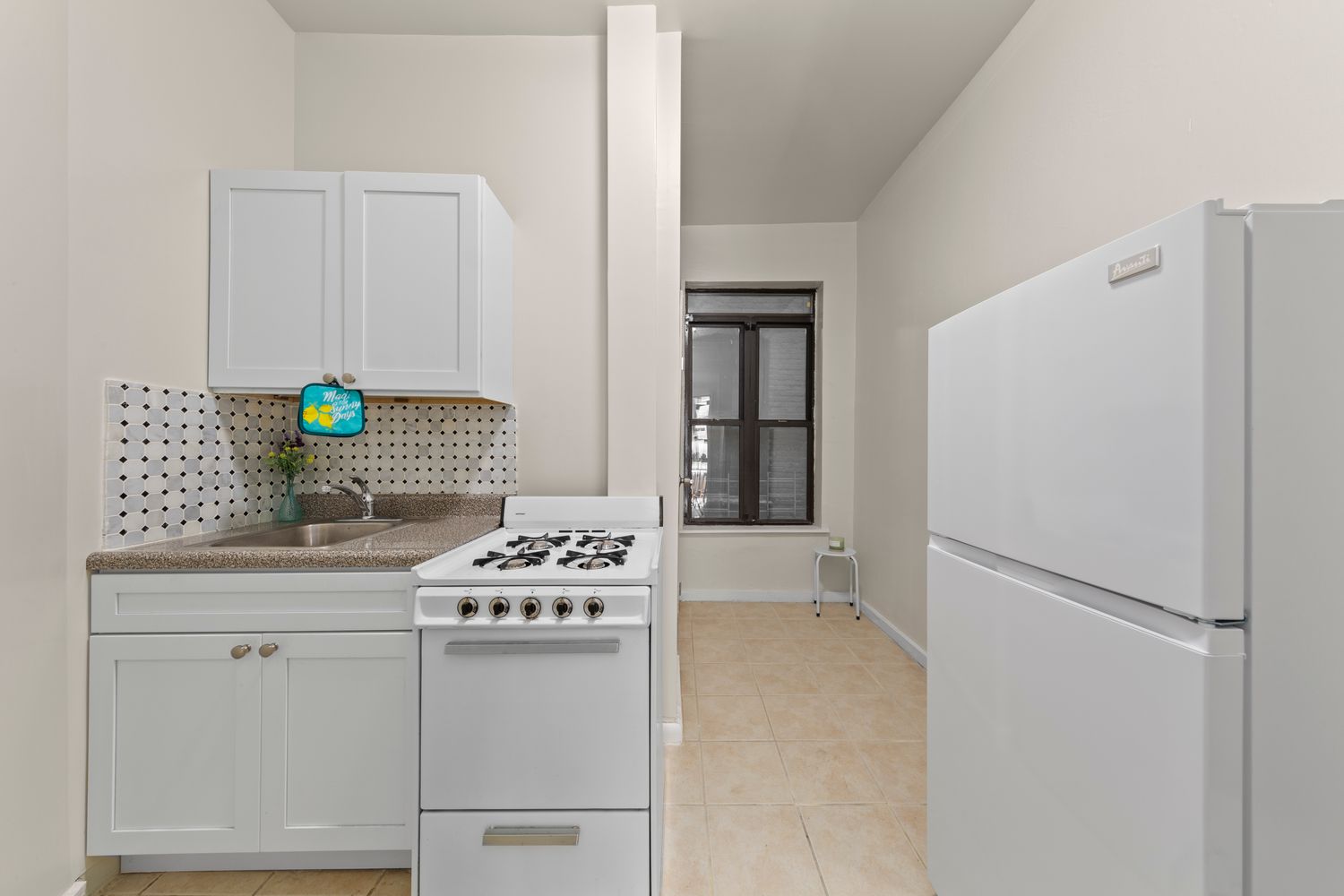 1777 Madison Avenue, Unit 32 Manhattan, NY 10035 - Photo 11 of 16 a kitchen with stainless steel appliances a stove a refrigerator and a white cabinets