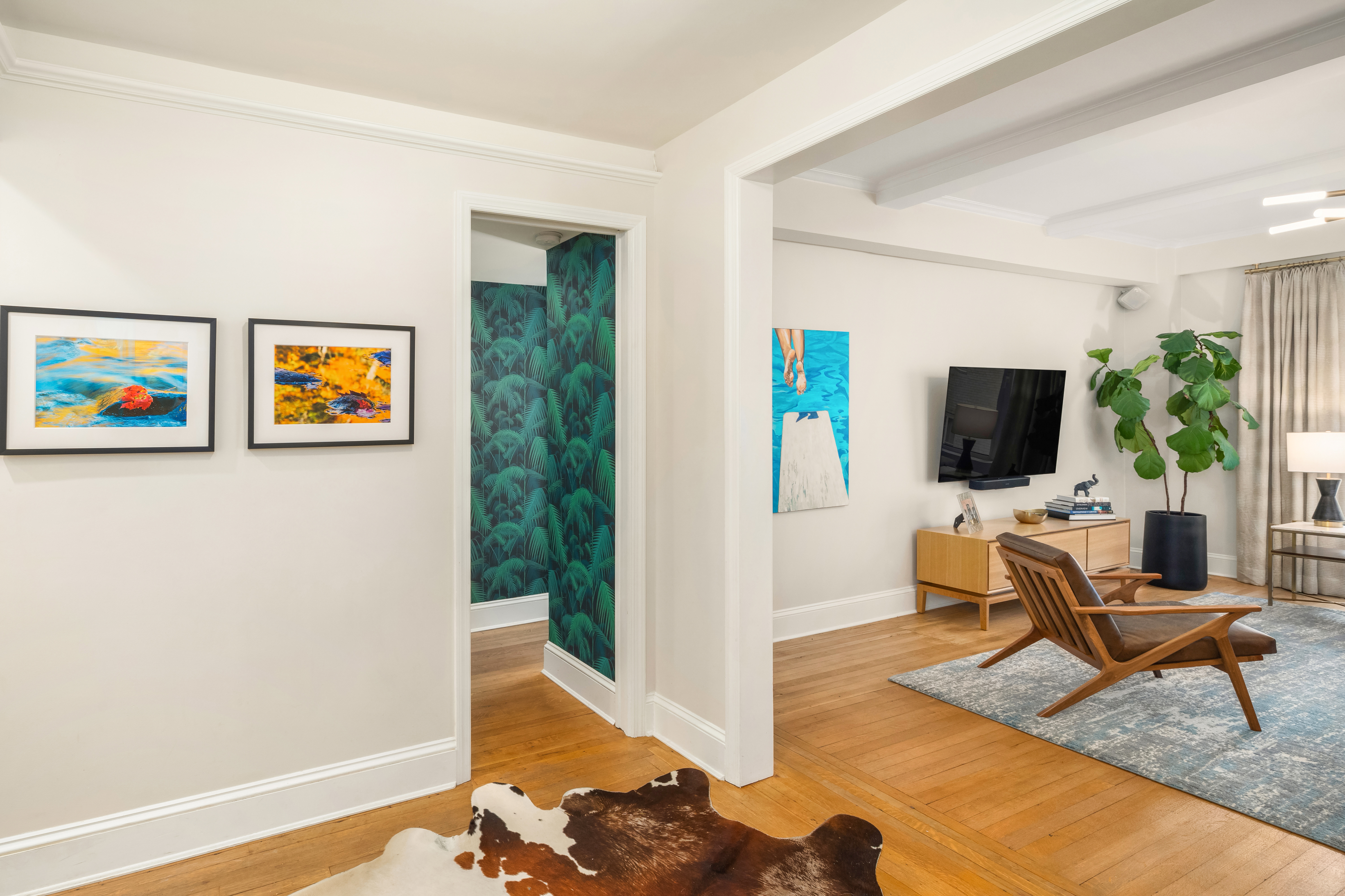 138 East 36th Street, Unit 4C Manhattan, NY 10016 - Photo 14 of 17 a living room with furniture and a flat screen tv