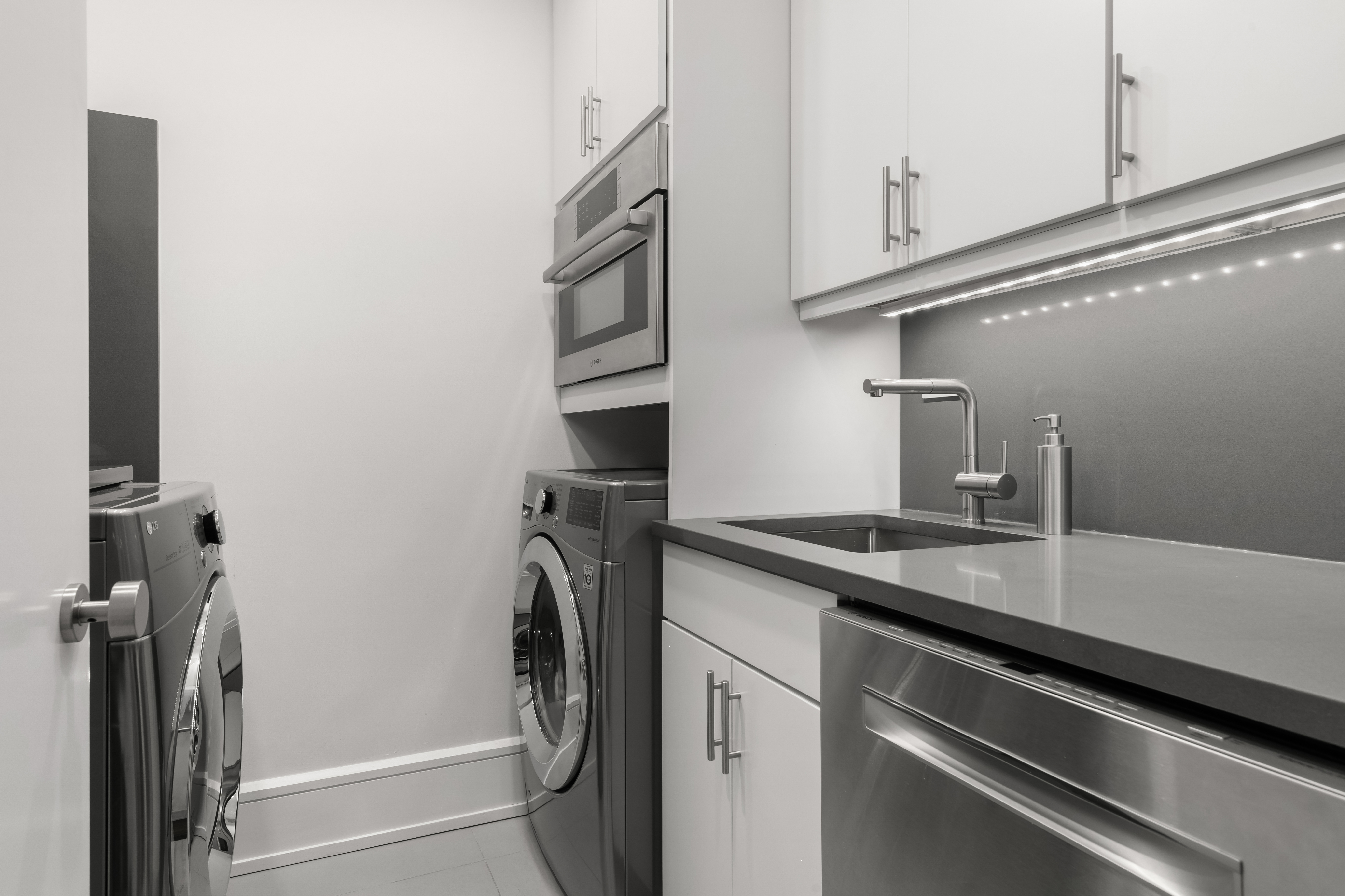 150 East 93rd Street, Unit 6AC Manhattan, NY 10128 - Photo 13 of 17 a kitchen with a sink and washing machine