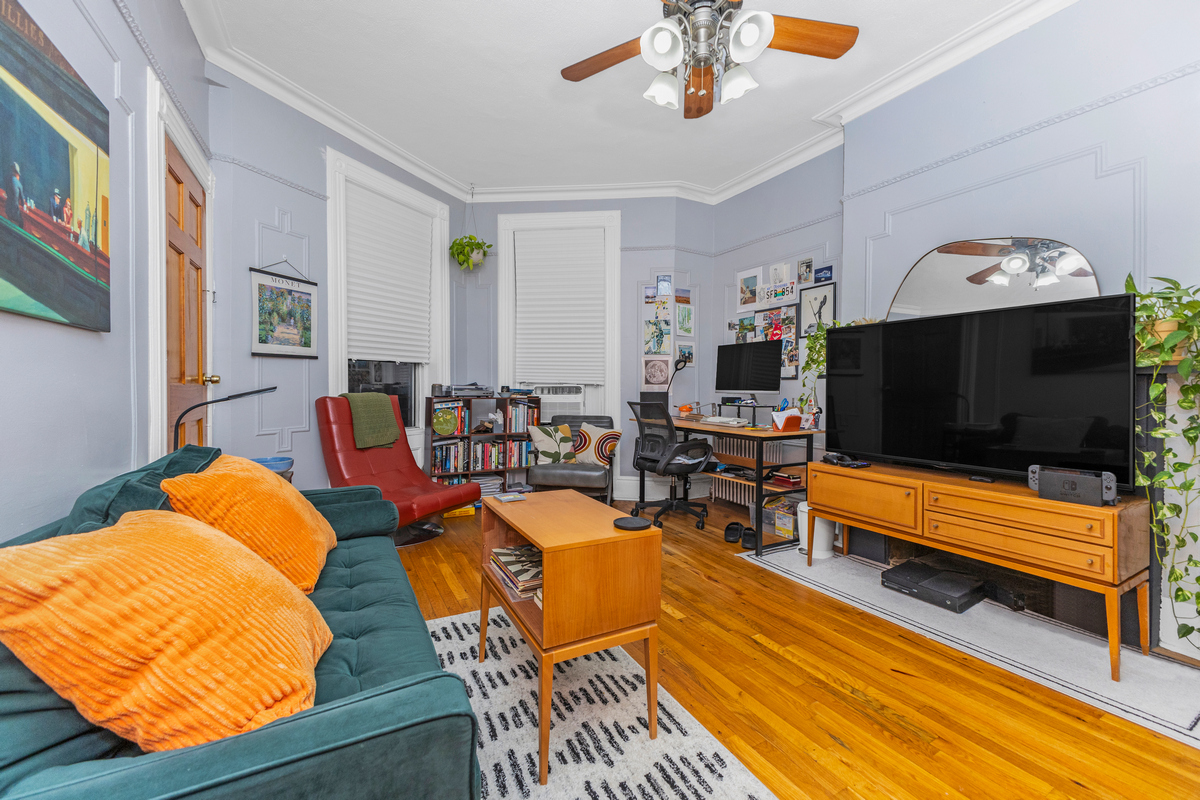 397 Douglass Street Brooklyn, NY 11217 - Photo 4 of 15 a living room with furniture a flat screen tv and kitchen view