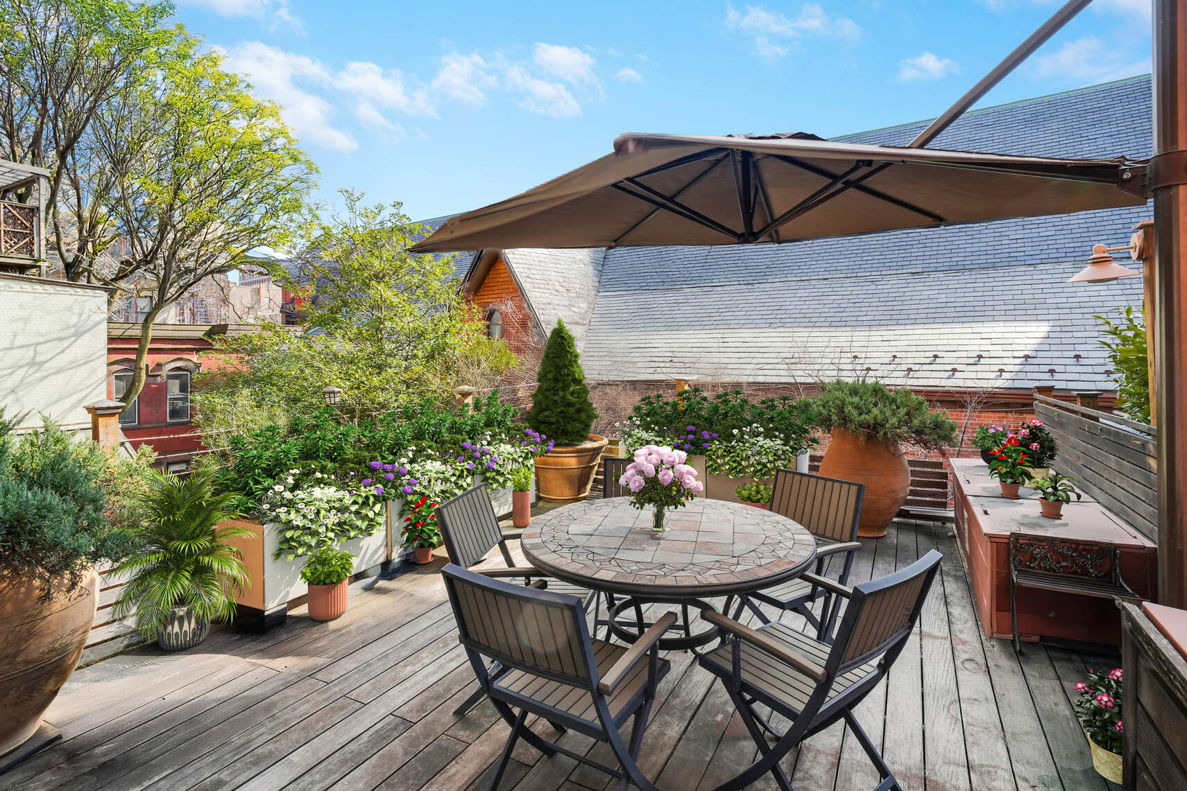 132 Joralemon Street, Unit 3BC Brooklyn, NY 11201 - Photo 14 of 16 a view of a patio with table and chairs under an umbrella