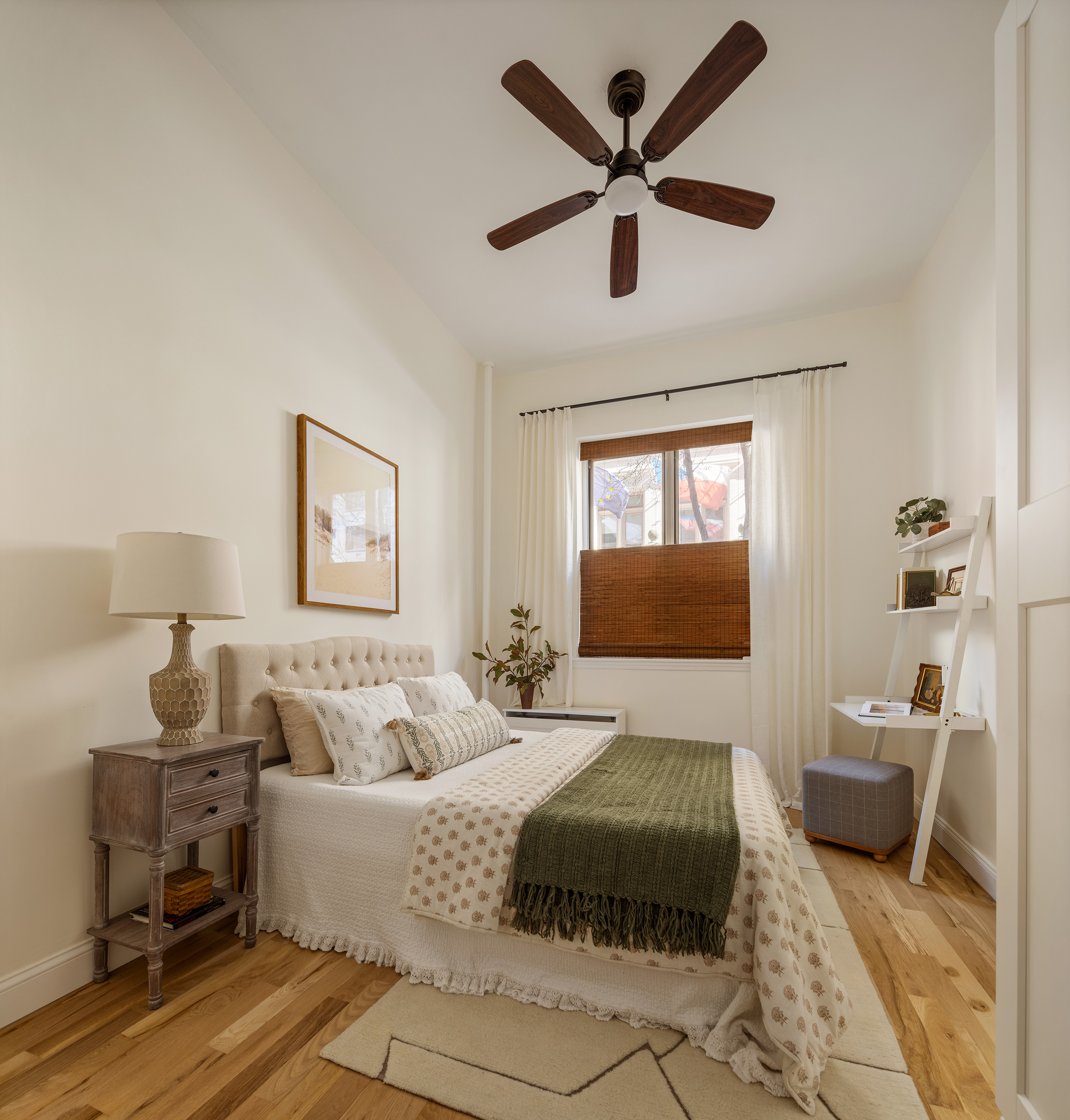 326 East 73rd Street, Unit 1A Manhattan, NY 10021 - Photo 3 of 6 a bedroom with a bed a couch and a window