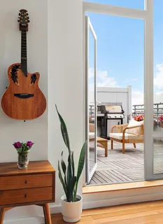 a living room with furniture and a potted plant
