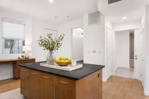 a view of kitchen island sink and refrigerator