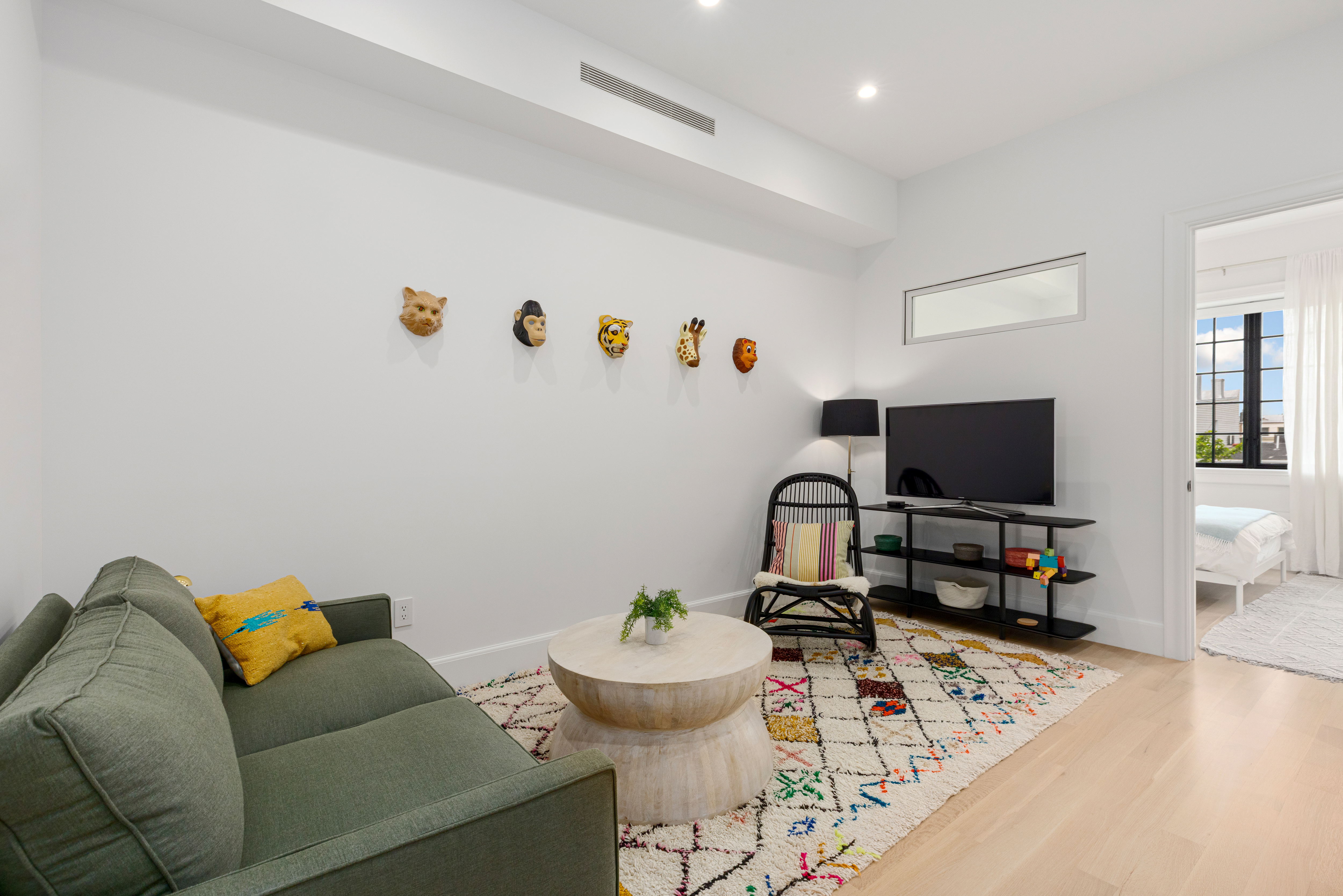 179 Devoe Street Brooklyn, NY 11211 - Photo 11 of 20 a living room with furniture and a flat screen tv