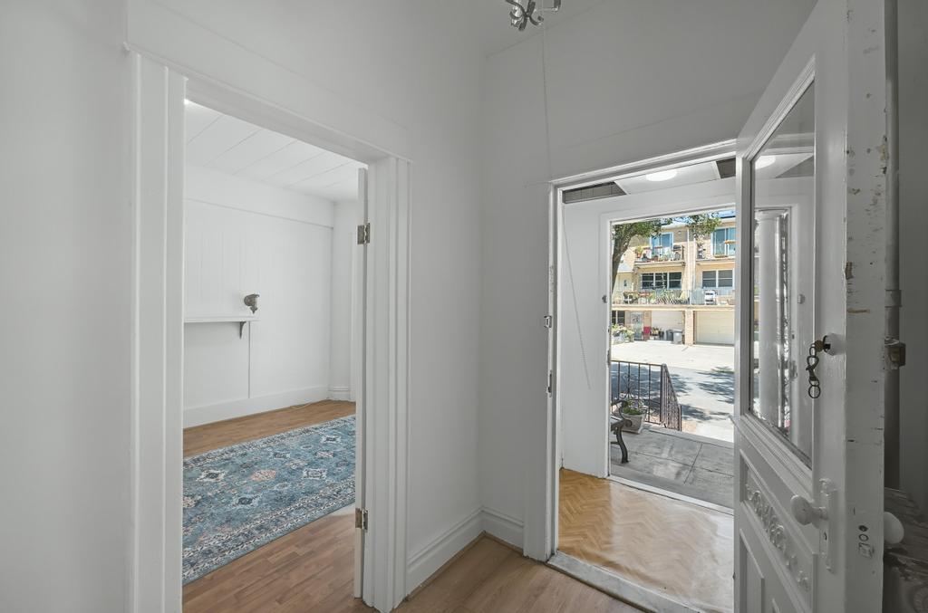 10 Seeley Street Brooklyn, NY 11218 - Photo 3 of 27 a bathroom with a glass shower door and a sink