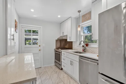 a kitchen with a sink stove and cabinets