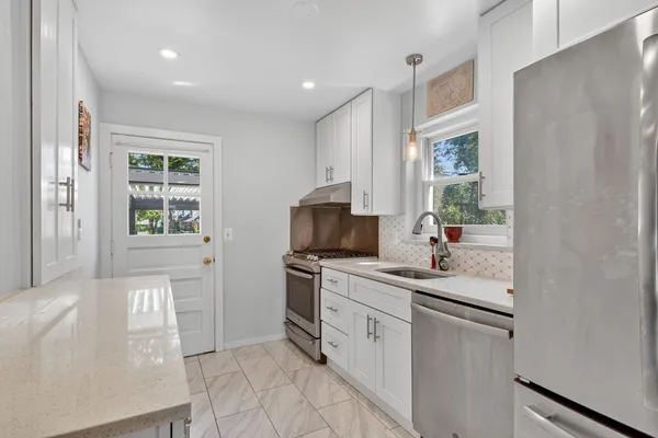 a kitchen with a sink stove and cabinets