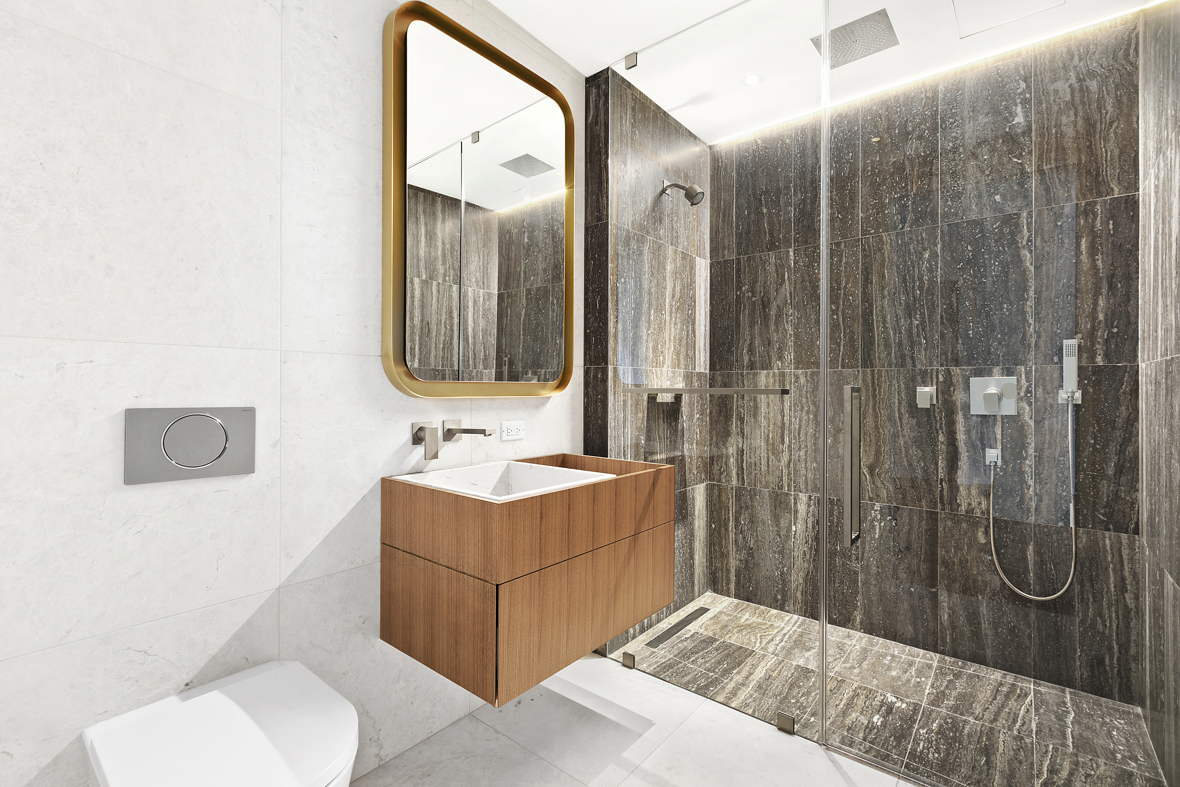 75 Kenmare Street, Unit 3B Manhattan, NY 10012 - Photo 4 of 8 a en suite bathroom with a toilet sink and mirror