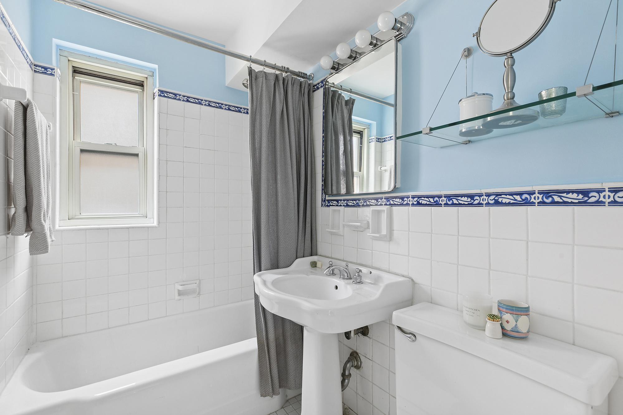 1199 Park Avenue, Unit 2F Manhattan, NY 10128 - Photo 9 of 12 a bathroom with a sink a bathtub and shower