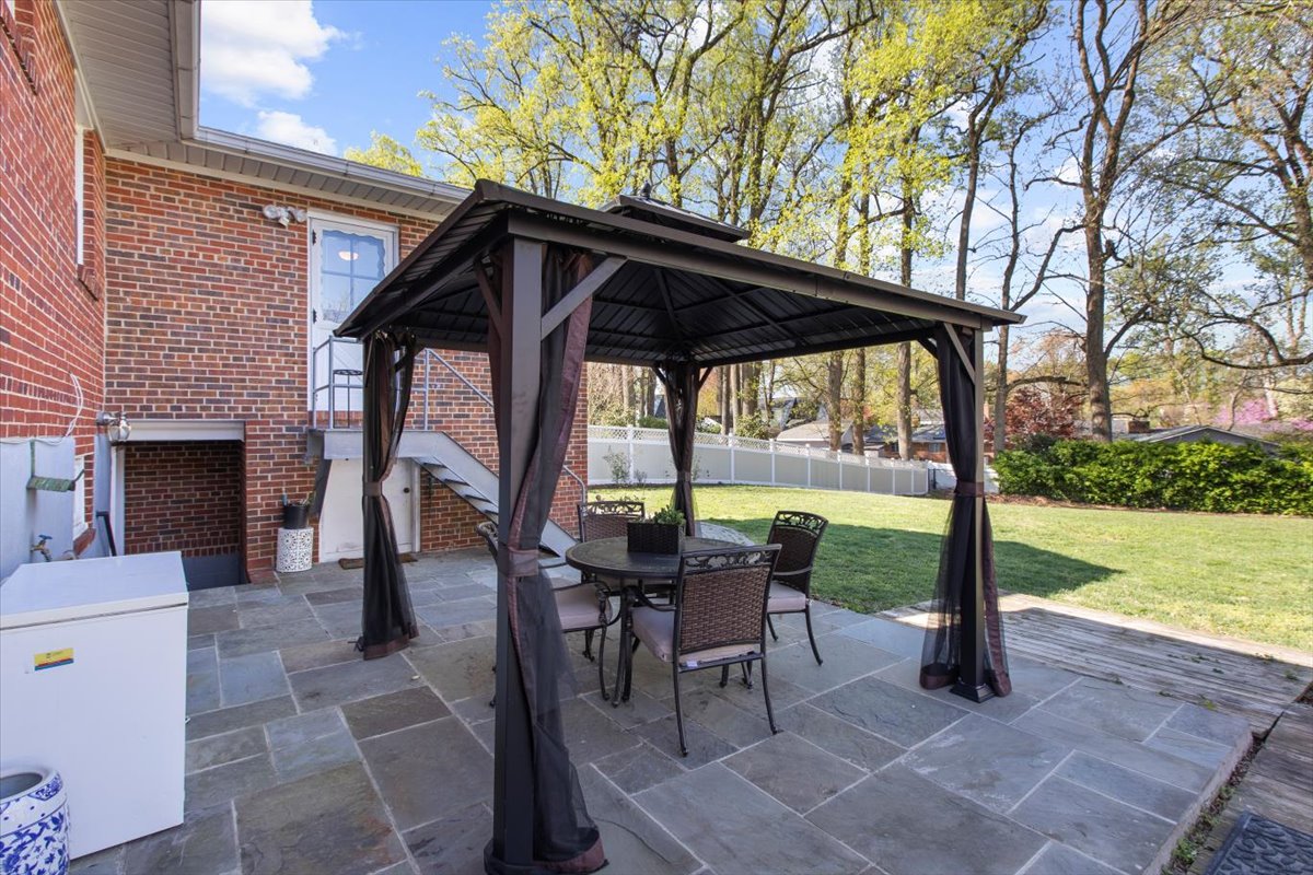 12712 Atherton Drive Silver Spring, MD 20906 - Photo 34 of 40 a view of a patio with a table chairs and a backyard