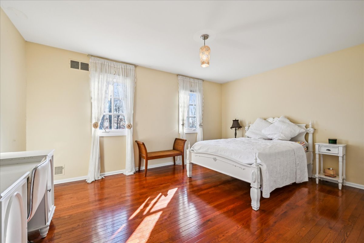 Johnston Drive Watchung, NJ 07069 - Photo 52 of 85 a spacious bedroom with a bed and a table in it