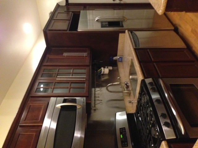 250 57th Street Brooklyn, NY 11220 - Photo 5 of 15 a kitchen with granite countertop a stove and a microwave