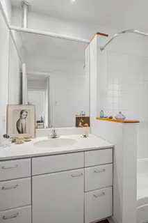a bathroom with a sink vanity granite and a mirror