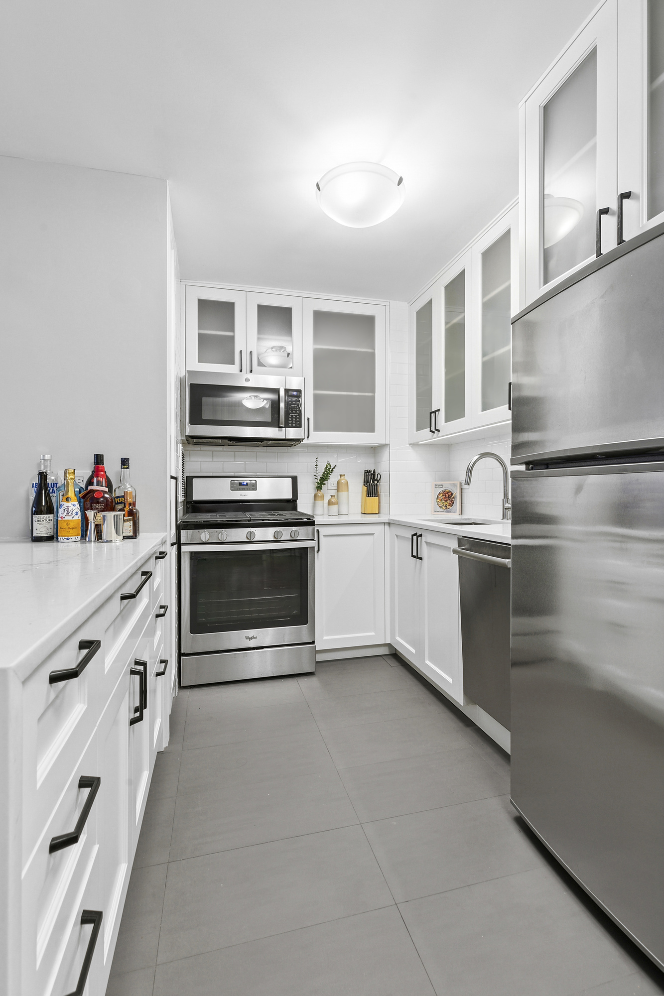 16 West 16th Street, Unit 3RN Manhattan, NY 10011 - Photo 3 of 9 a kitchen with stainless steel appliances a stove a sink and a refrigerator