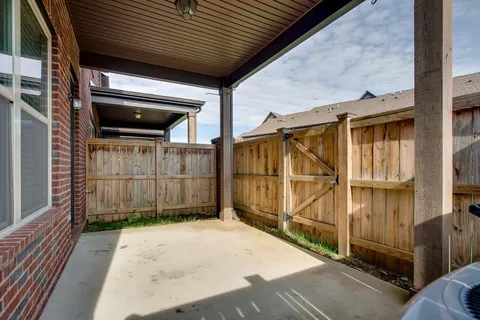 a view of a house with a wooden fence
