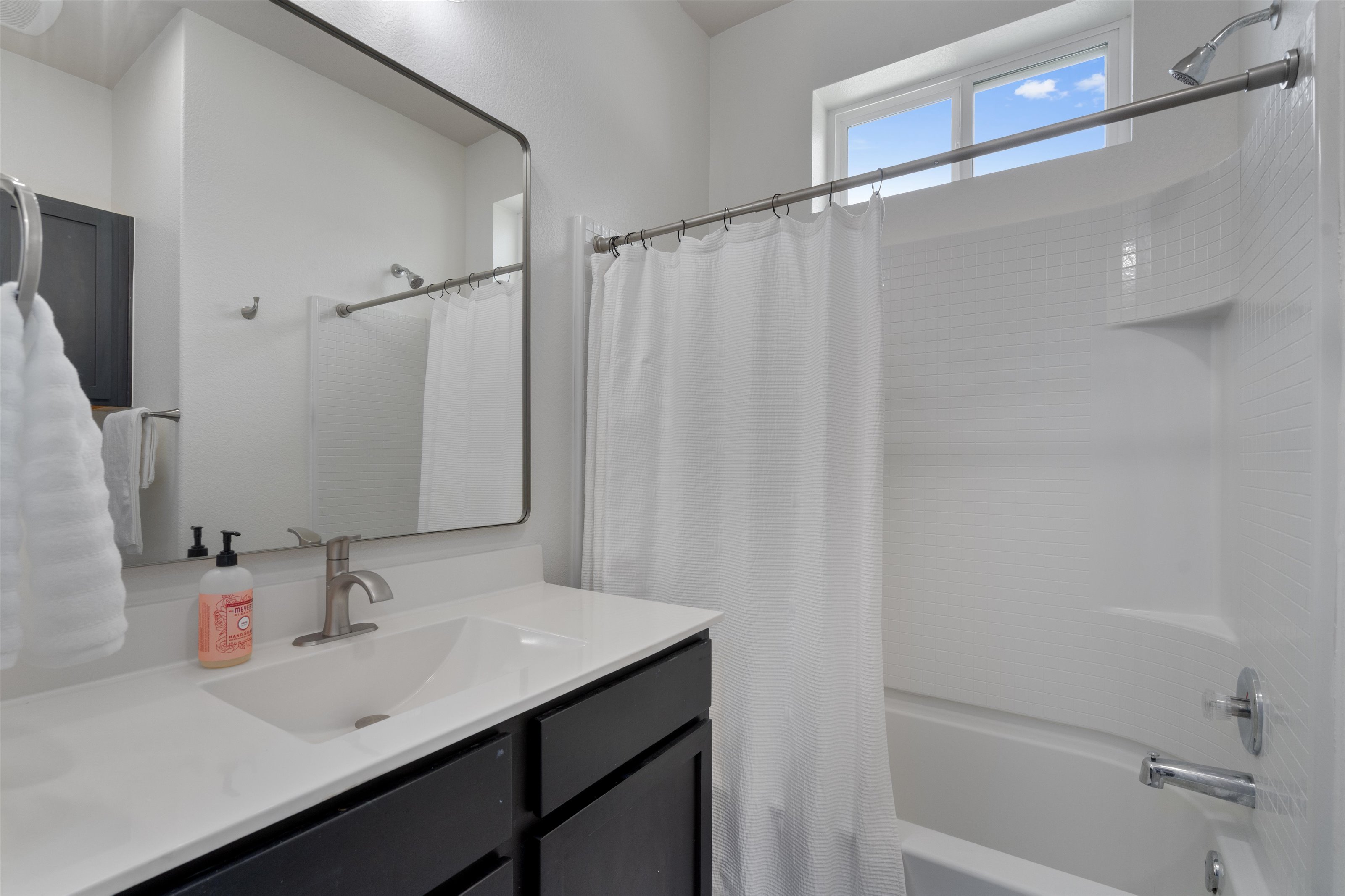 4330 Olenick Street Austin, TX 78723 - Photo 13 of 29 a bathroom with a sink and a mirror