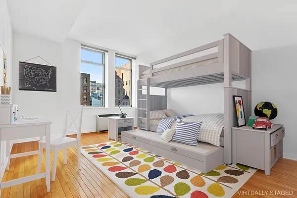 252 7th Avenue, Unit 10I Manhattan, NY 10001 - Photo 10 of 25 a bedroom with furniture and a table