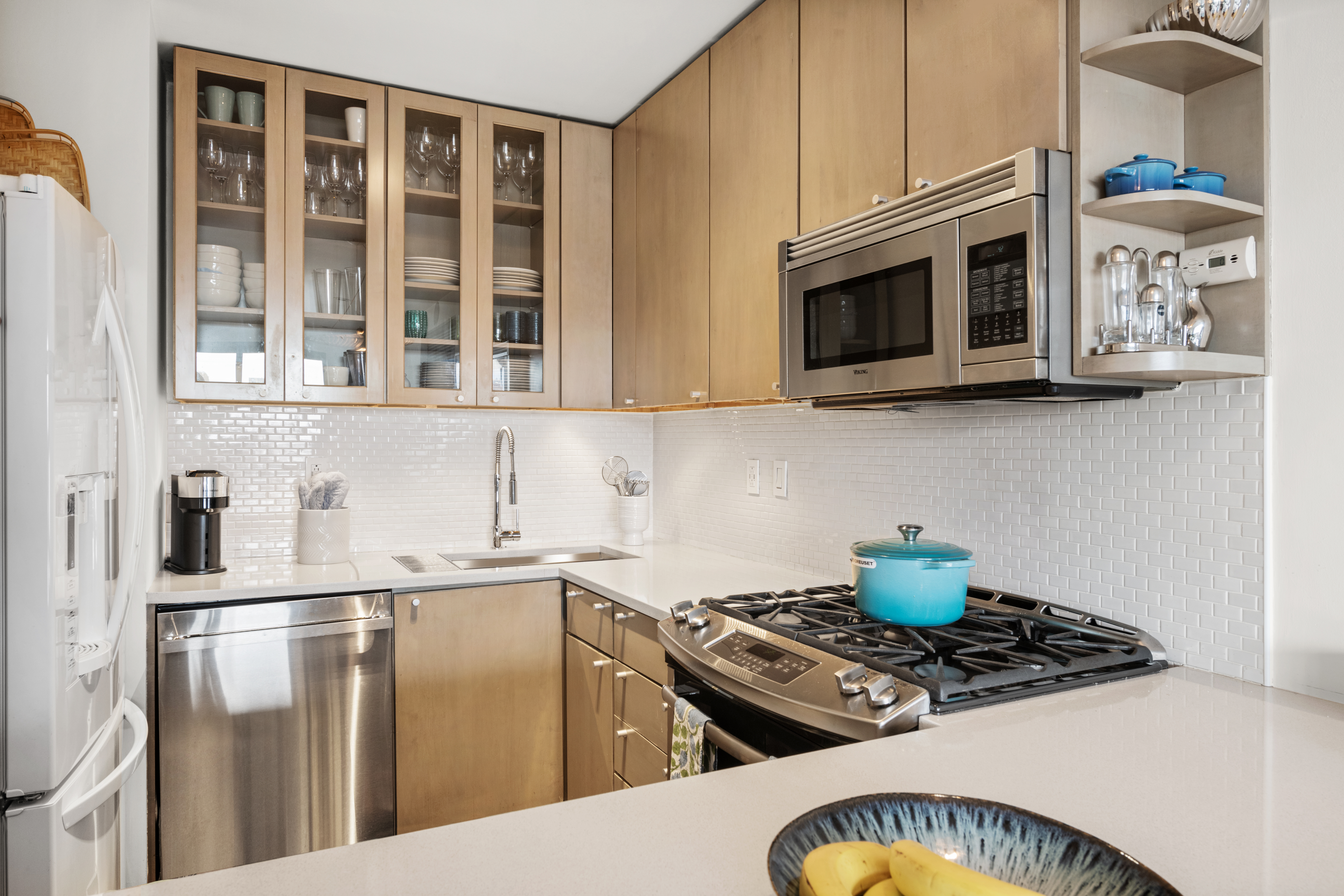 181 7th Avenue, Unit 11A Manhattan, NY 10011 - Photo 5 of 13 a kitchen with stainless steel appliances granite countertop a stove and a microwave