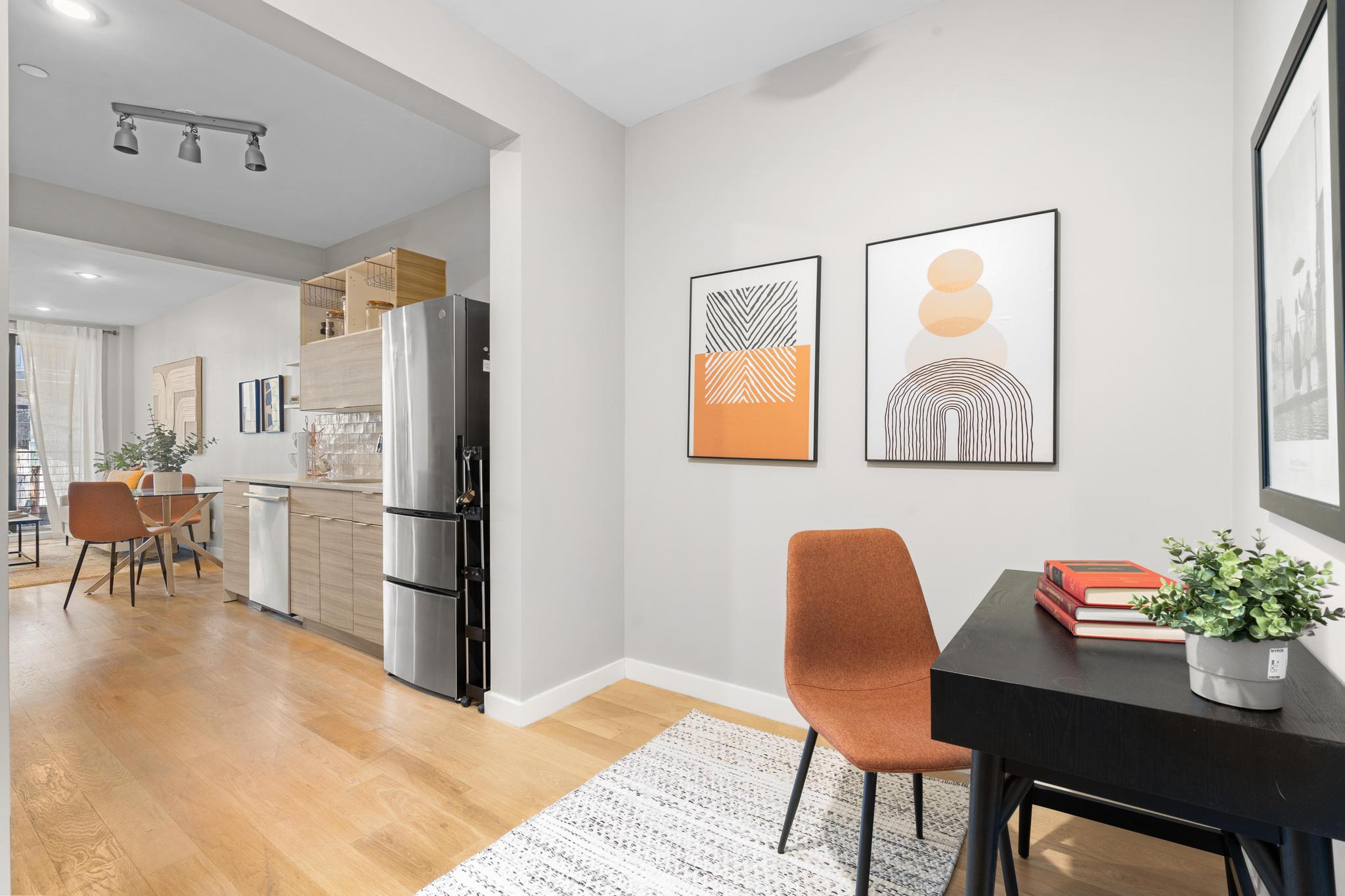 516 Classon Avenue, Unit 2B Brooklyn, NY 11238 - Photo 4 of 9 a kitchen with stainless steel appliances granite countertop a refrigerator a stove a dining table and chairs with wooden floor