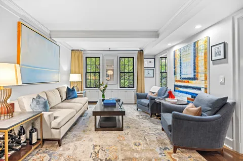 a living room with furniture and large windows