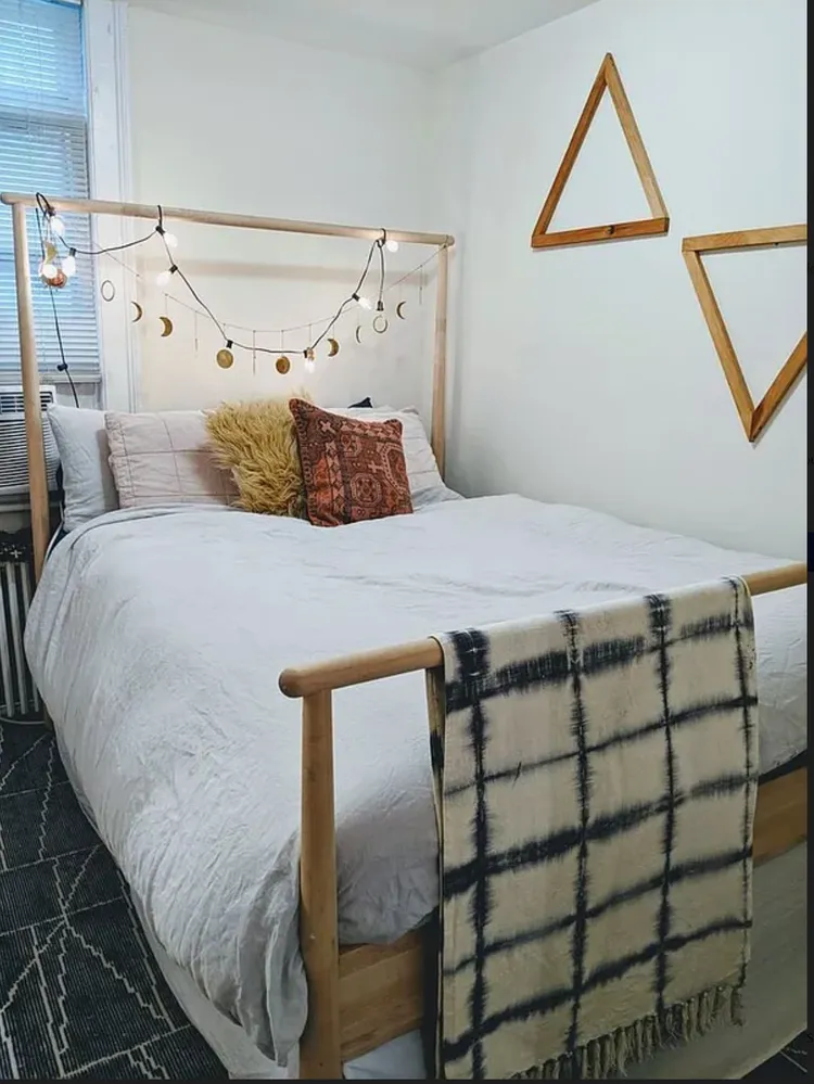 a bedroom with a bed and a painting on the wall