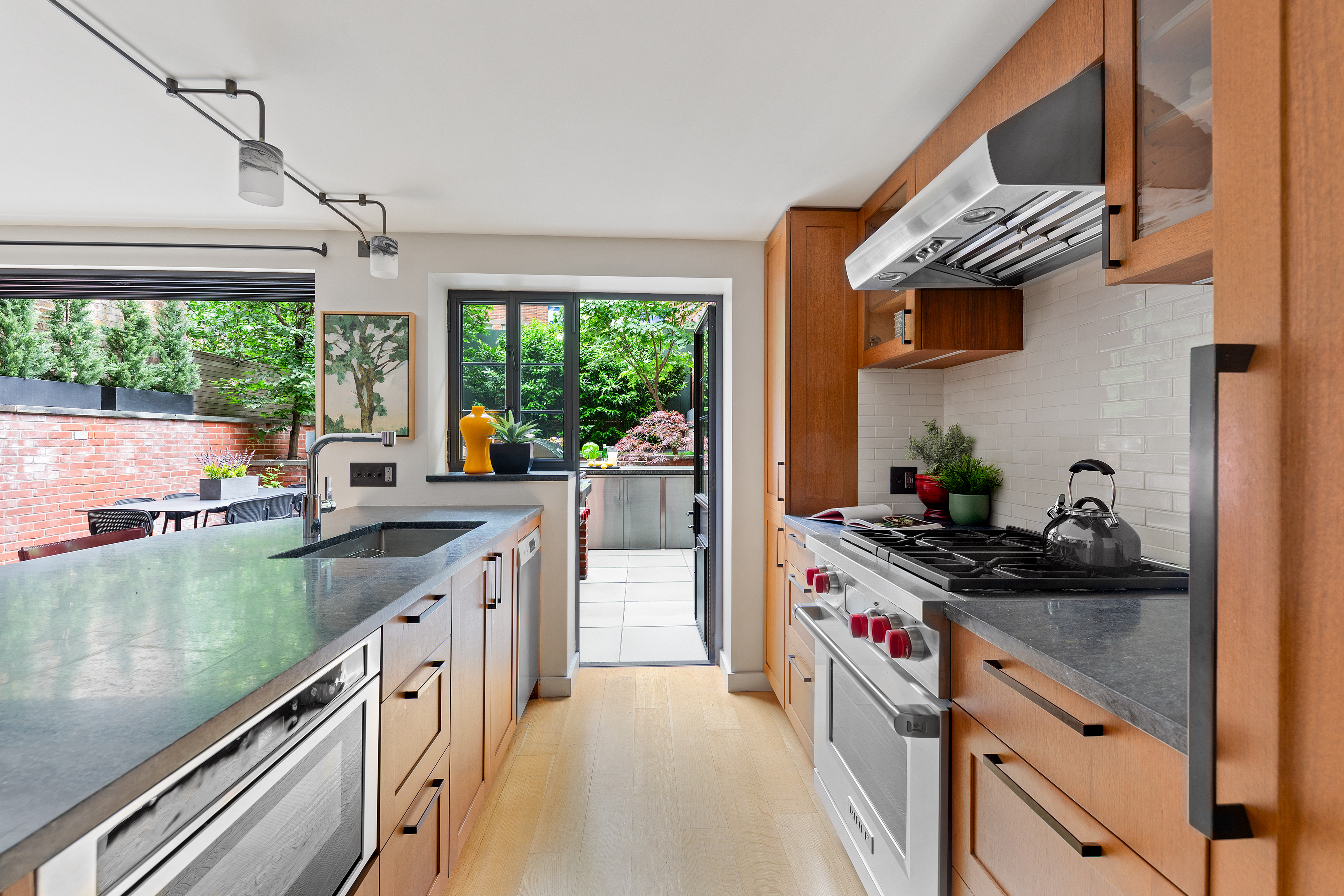 21 Bethune Street, Unit GARDEN Manhattan, NY 10014 - Photo 5 of 12 a kitchen with a sink stove and refrigerator