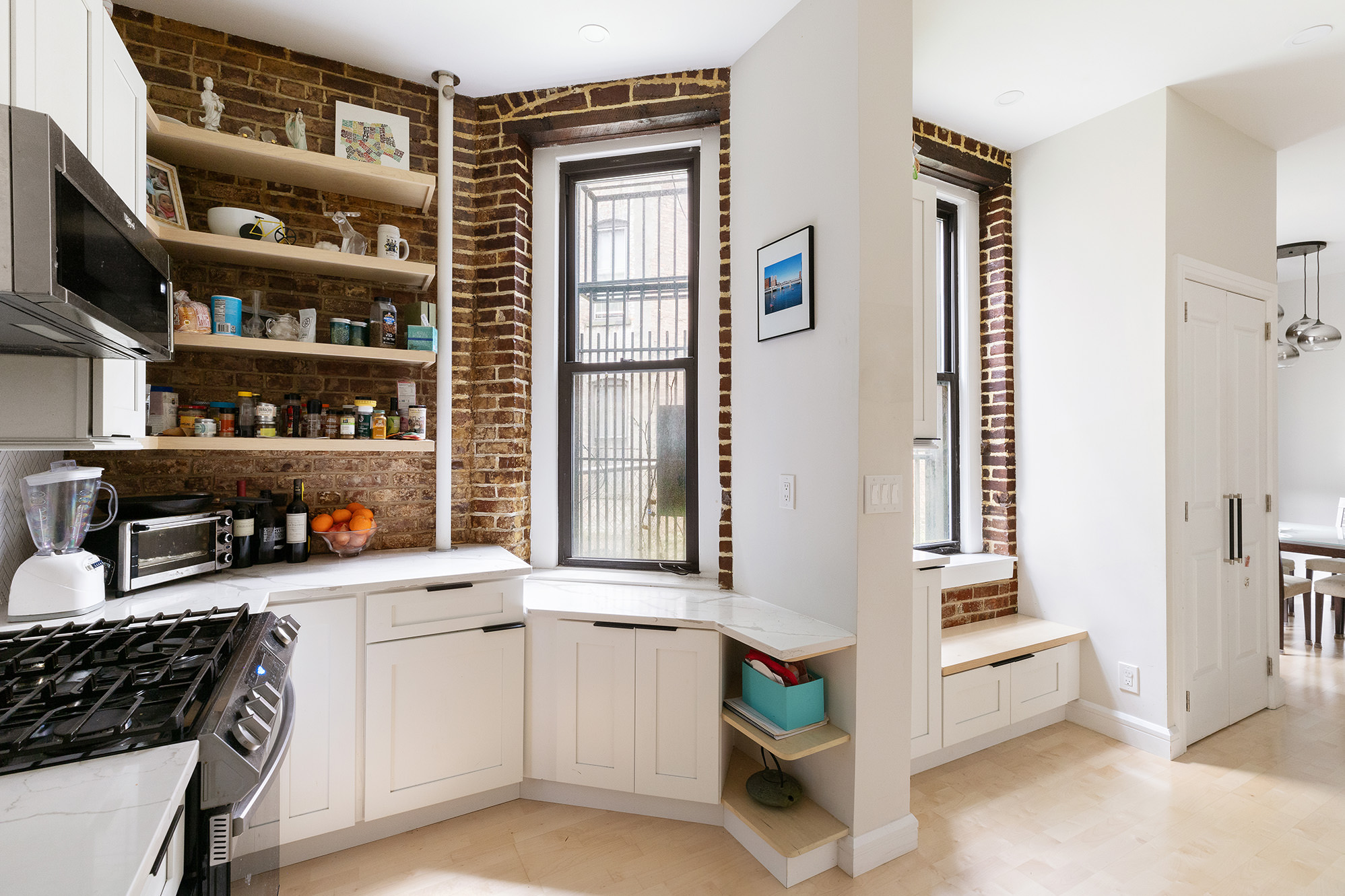 330 East 94th Street, Unit 1AB Manhattan, NY 10128 - Photo 3 of 14 a kitchen with stainless steel appliances cabinets and a window