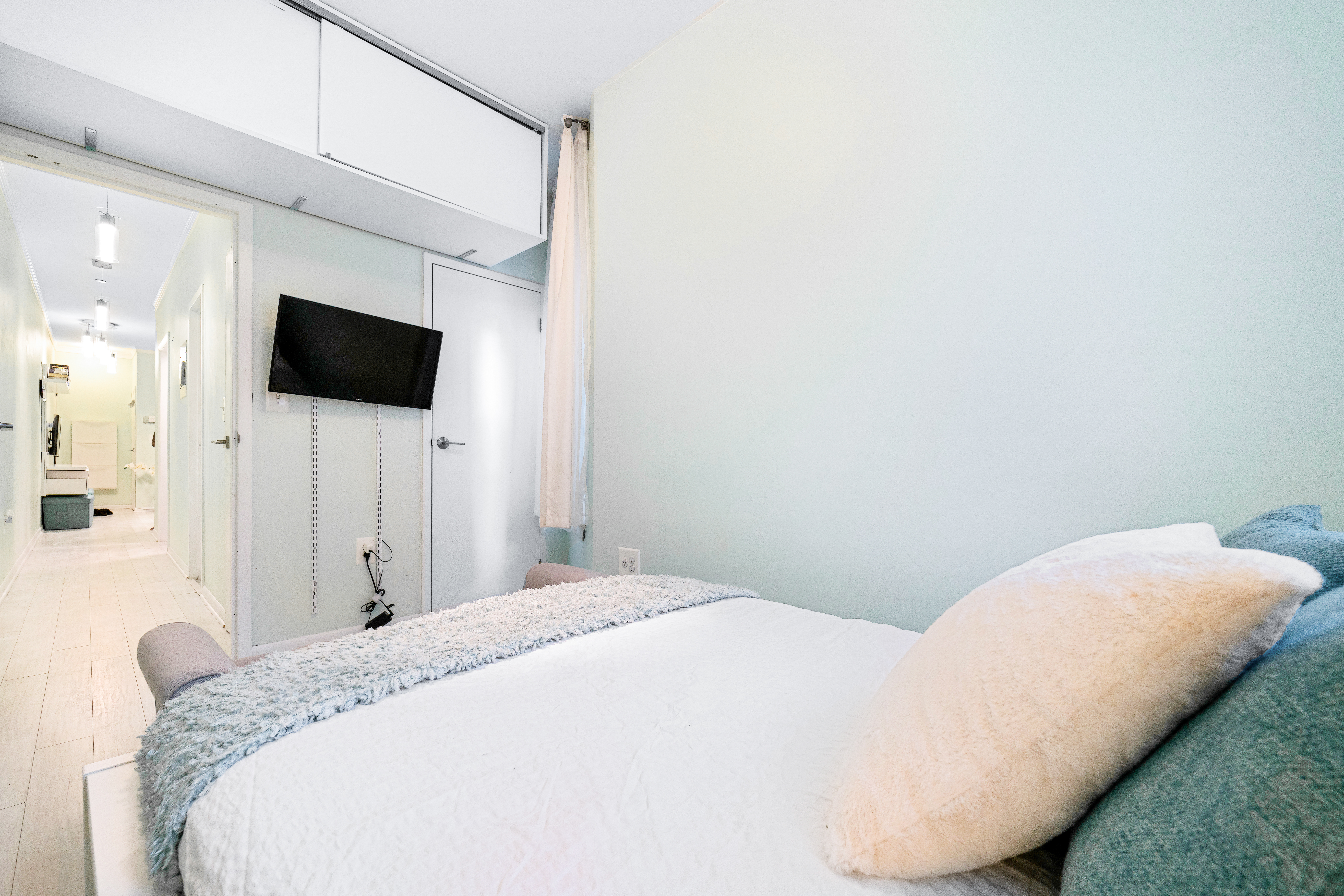 108 West 114th Street, Unit 4B Manhattan, NY 10026 - Photo 7 of 9 a bedroom with a bed and a flat screen tv