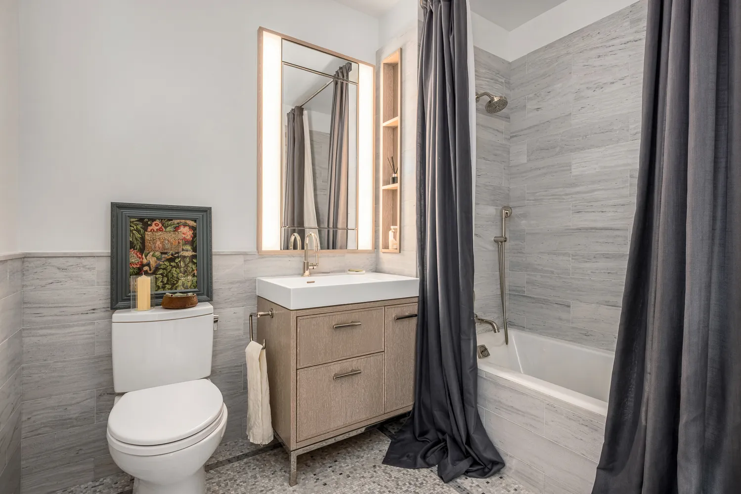 a bathroom with a granite countertop toilet a sink and a mirror