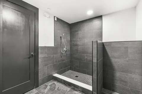 a bathroom with a shower a toilet and sink